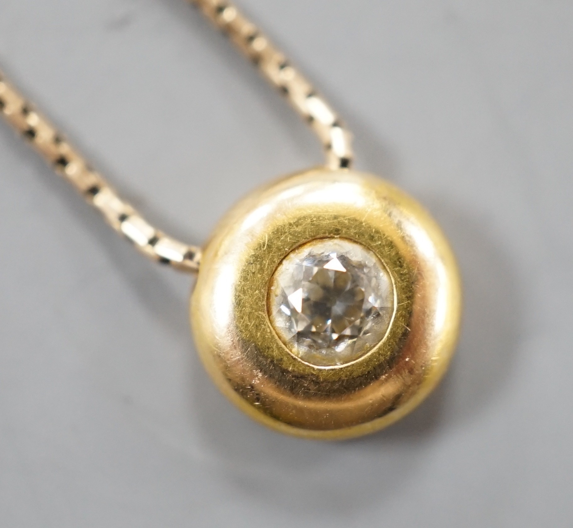 A modern 9ct gold and solitaire diamond set pendant necklace, pendant 9mm, chain, 39cm, gross weight 4.5 grams.